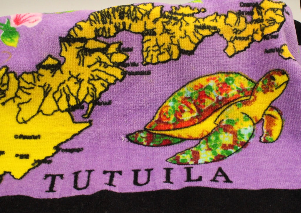 Tropical designs of the island of Tutuila and turtles on a purple 100% cotton hand towel